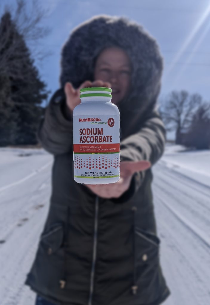 woman holding a bottle of sodium ascorbate
