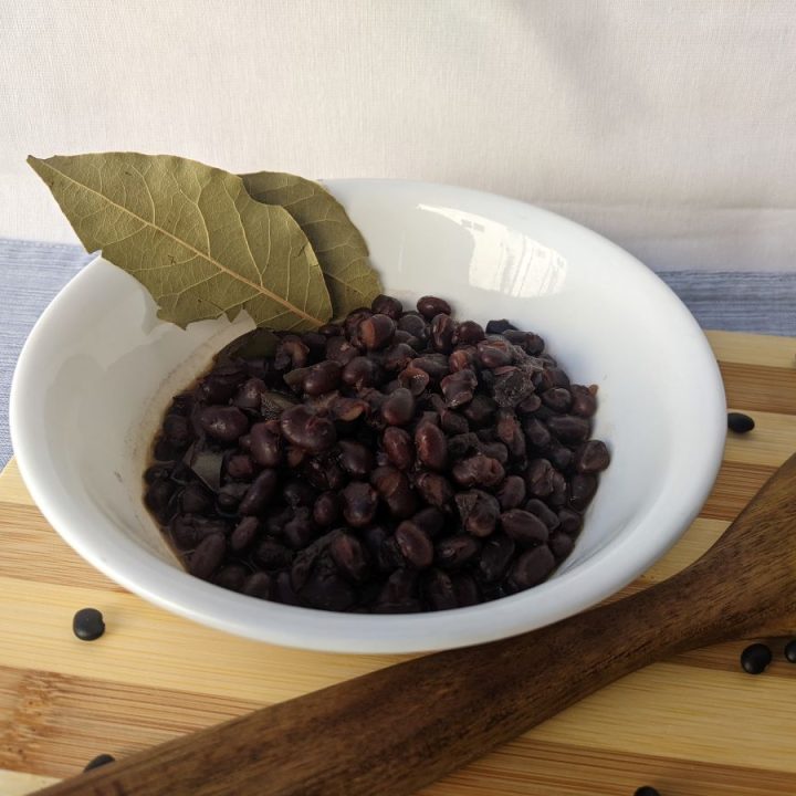 black beans in a bowl on top of a cutting board