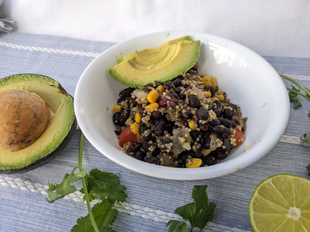 black bean quinoa skillet in a bowl with avocado