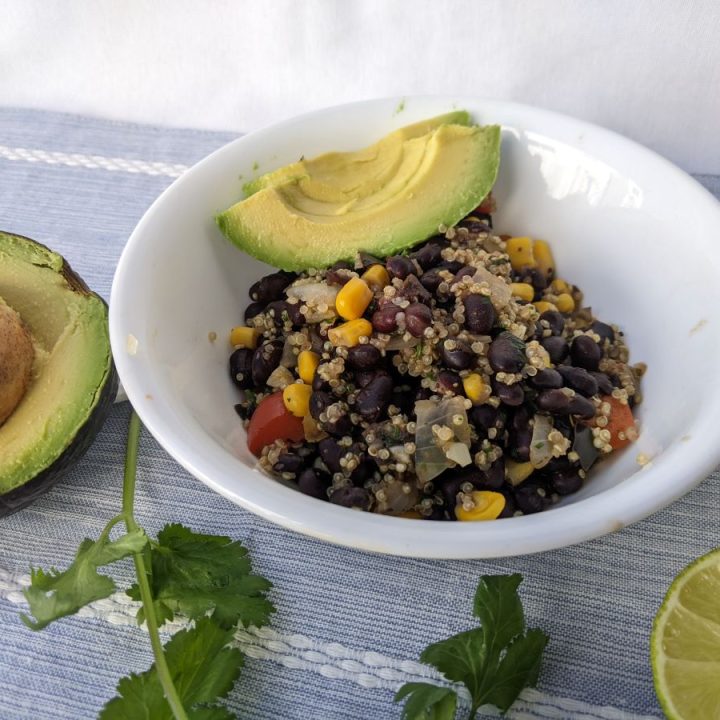black bean quinoa skillet in a bowl with avocado