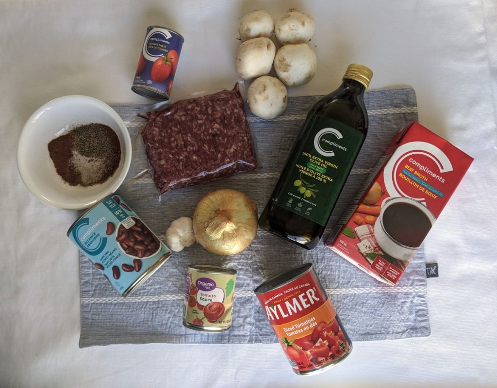 Ingredients to make chili laying on a table