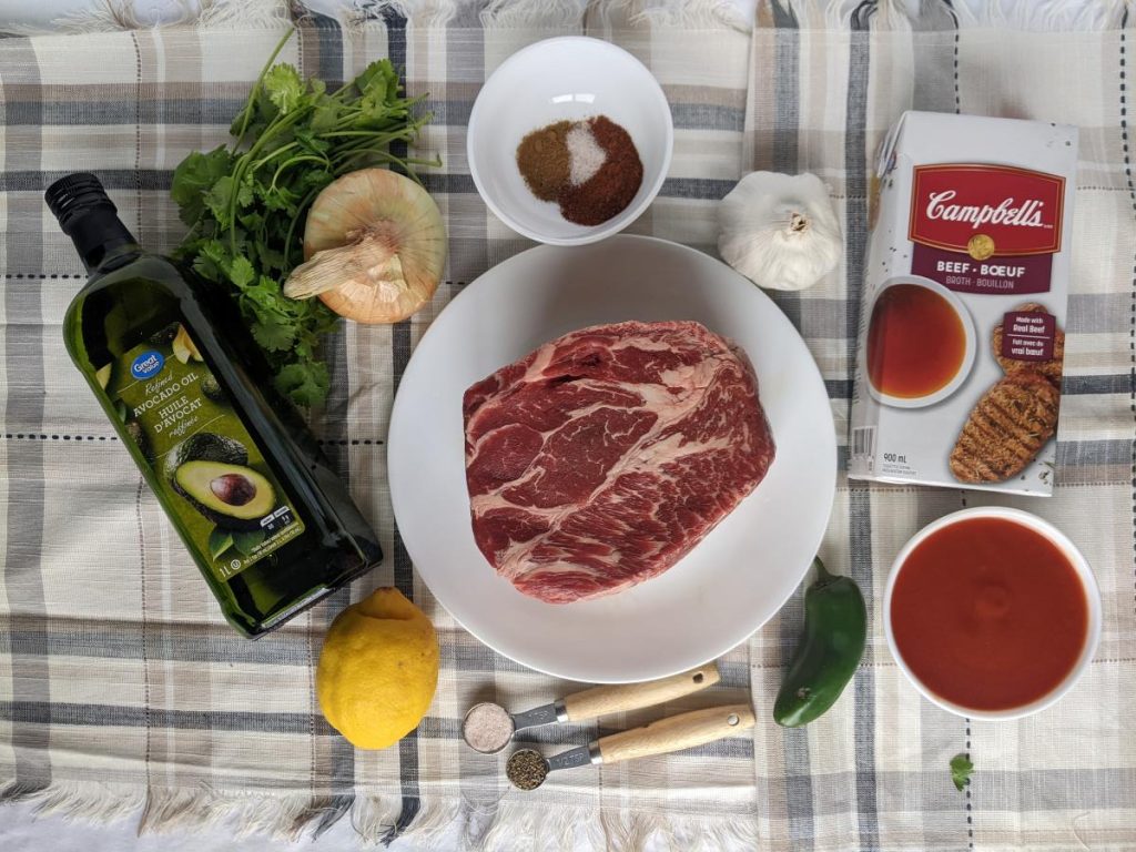 ingredients to make shredded beef laying on the table