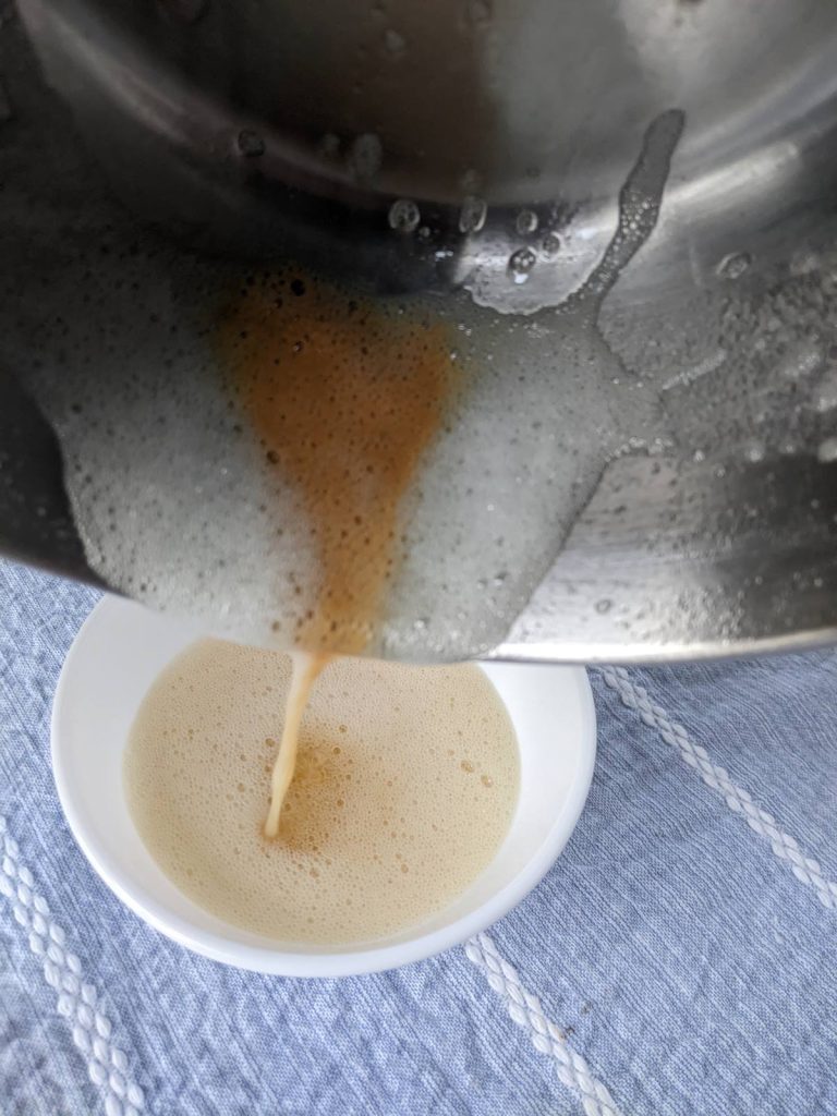 Browned butter being poured into a bowl