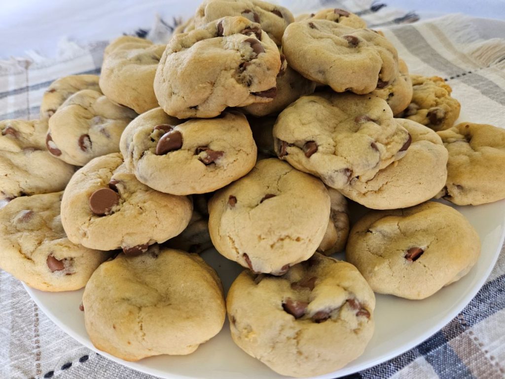 large pile of chocolate cream cheese cookies on a white plate