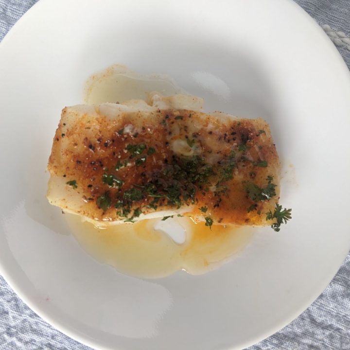 Cod on a plate drizzled in brown butter