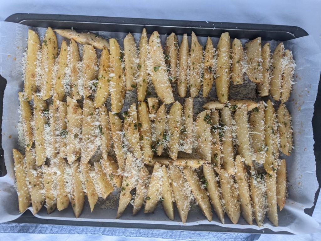 potato wedges on a tray ready to be baked