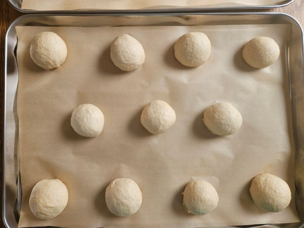 Buns in a baking tray waiting to rise.
